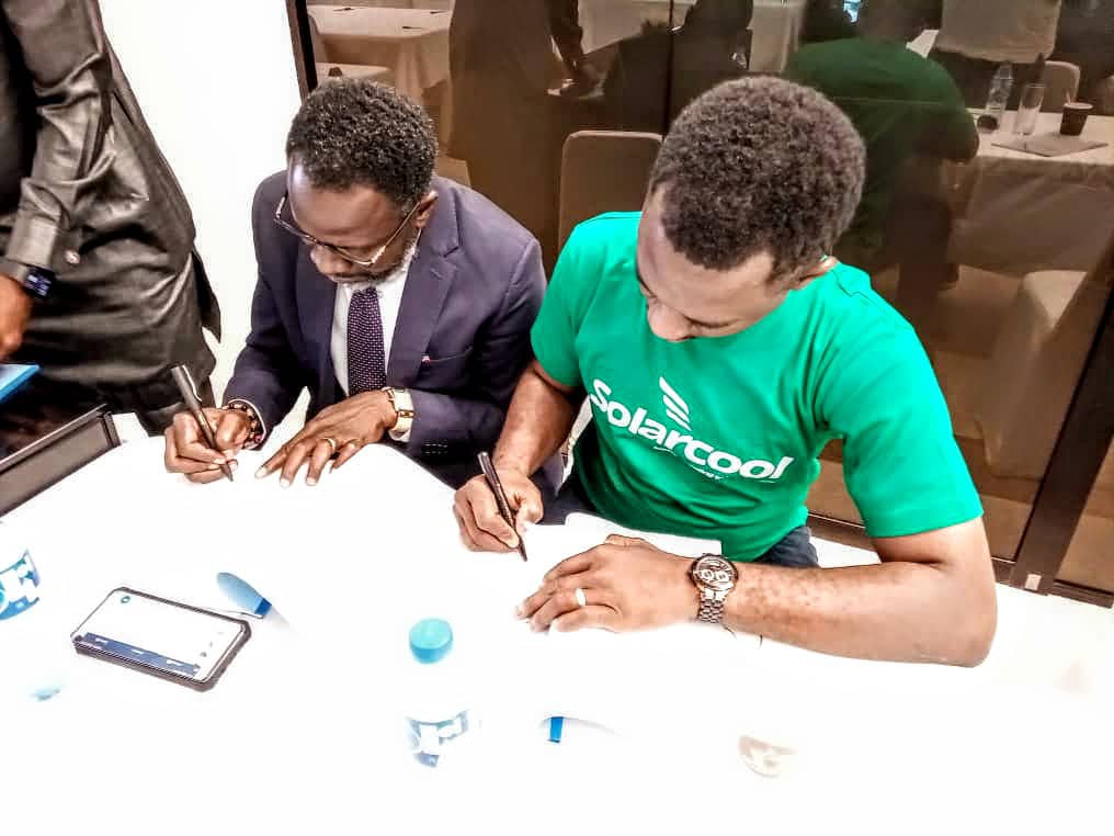 Larry Edeh and Dr. Chris Edeh of SolarCool signing the AfDB grants in Abuja, Nigeria